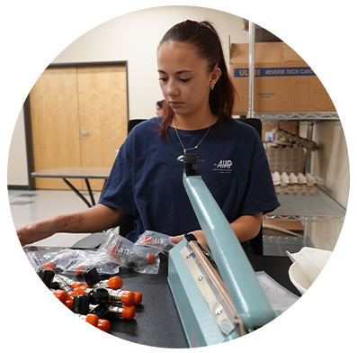 AIAP Employee Sealing parts in a bag for a kit.